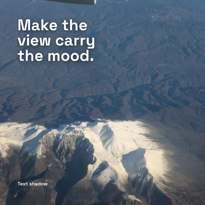 Card with large white text over an aerial photograph of mountains